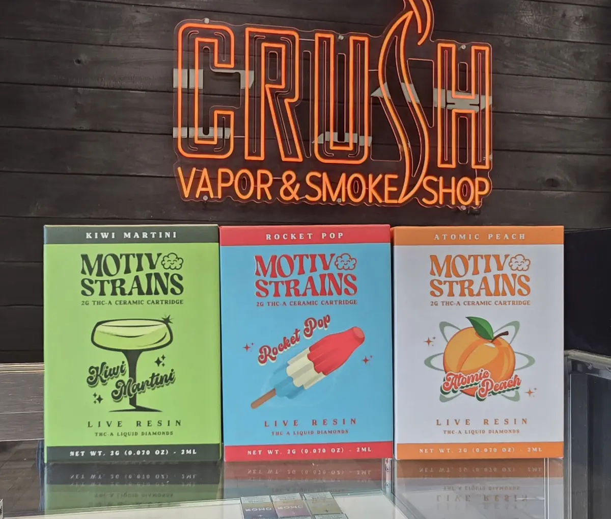Motiv Strains 2g THC-A live resin ceramic cartridges — Kiwi Martini, Rocket Pop, and Atomic Peach — at Crush Vapor & Smoke Shop.